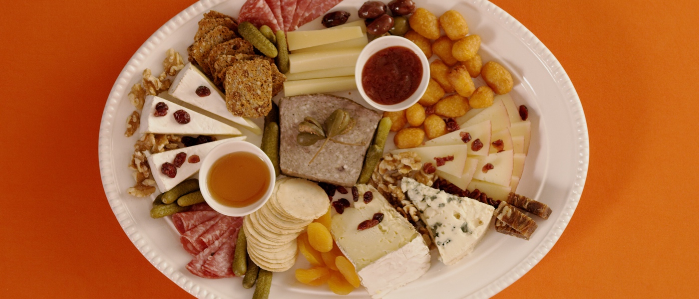 Overhead photo of Holiday Char-curd-erie Board on an orange background.